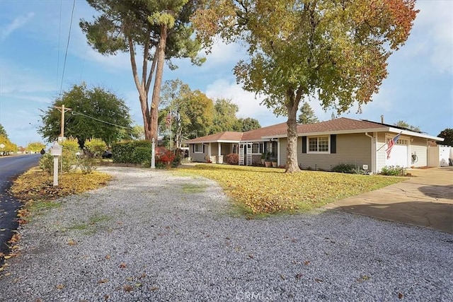 ranch-style house featuring a garage and driveway