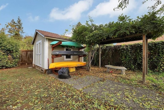 view of outbuilding with a fenced backyard and an outdoor structure