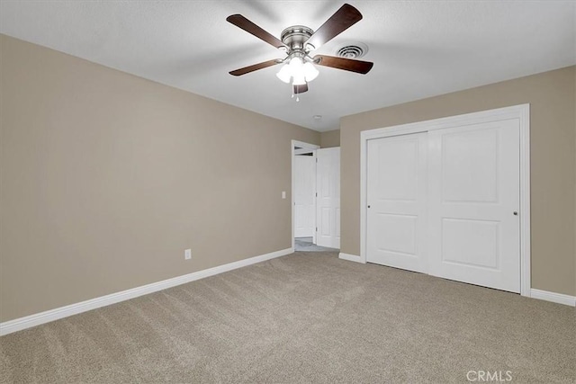 unfurnished bedroom with ceiling fan, carpet floors, visible vents, baseboards, and a closet