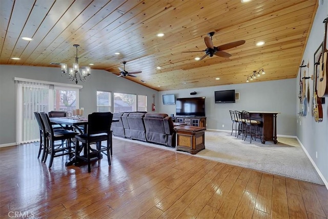 dining area featuring lofted ceiling, wood ceiling, baseboards, and hardwood / wood-style floors