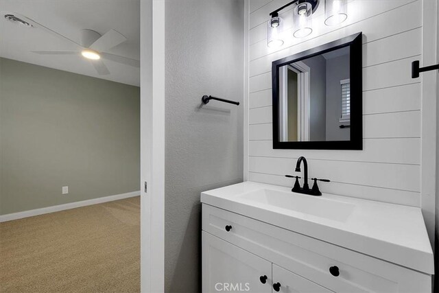 bathroom featuring a ceiling fan, visible vents, vanity, and baseboards