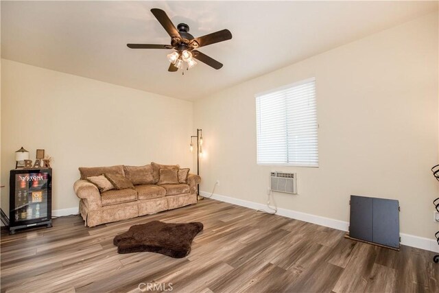 living room with an AC wall unit, ceiling fan, and hardwood / wood-style floors