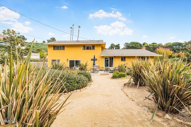 back of property featuring a patio area