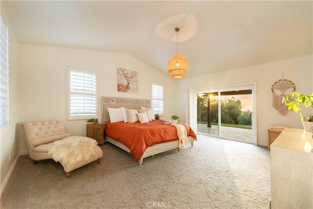 carpeted bedroom featuring access to exterior and vaulted ceiling