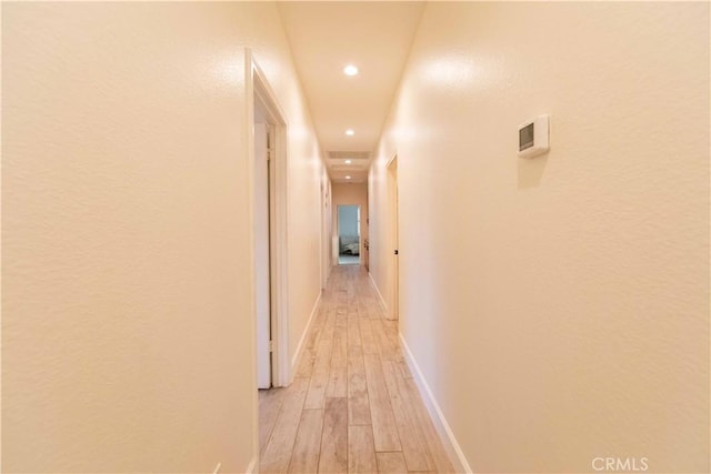 corridor with light hardwood / wood-style floors