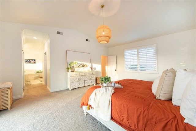 bedroom with carpet floors and vaulted ceiling