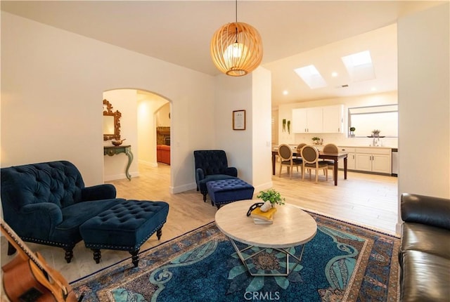 living room featuring light wood-type flooring and sink