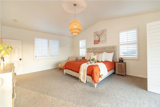 carpeted bedroom with lofted ceiling