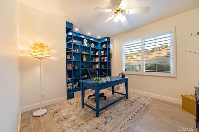 office featuring hardwood / wood-style flooring, ceiling fan, and ornamental molding