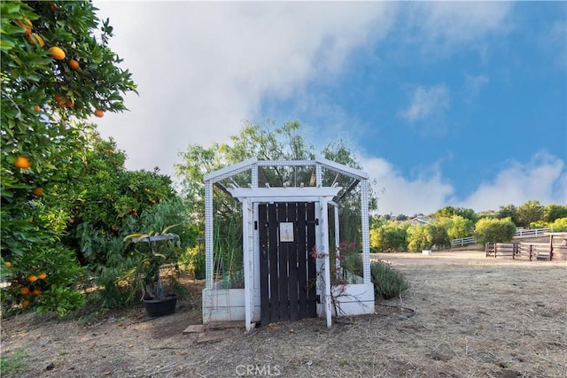 view of outbuilding with a rural view