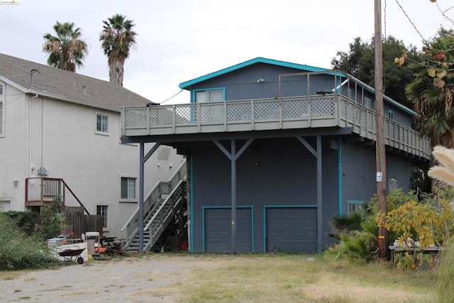 rear view of property featuring a wooden deck