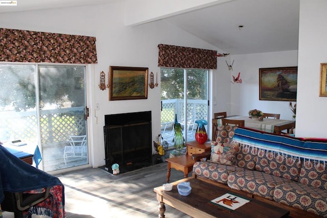 living room with lofted ceiling with beams