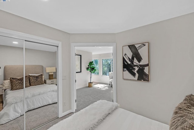 bedroom featuring light carpet and a closet