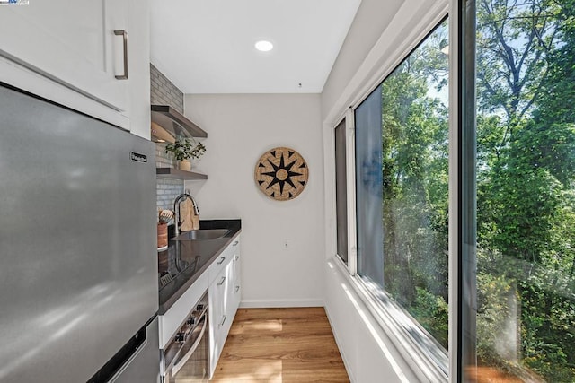 kitchen with white cabinetry, sink, plenty of natural light, and appliances with stainless steel finishes