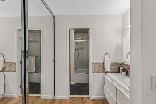 bathroom featuring hardwood / wood-style floors, vanity, and independent shower and bath