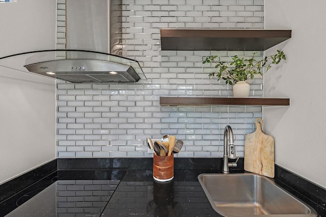 interior space featuring decorative backsplash, island range hood, and sink