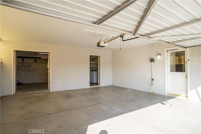 garage with washer / clothes dryer and a garage door opener