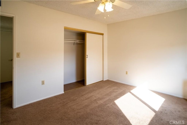 unfurnished bedroom featuring ceiling fan, carpet floors, and a textured ceiling