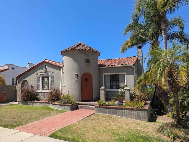 mediterranean / spanish-style house featuring a front lawn