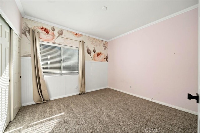 carpeted spare room featuring crown molding