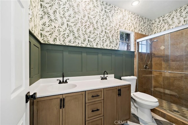 bathroom with an enclosed shower, vanity, and toilet