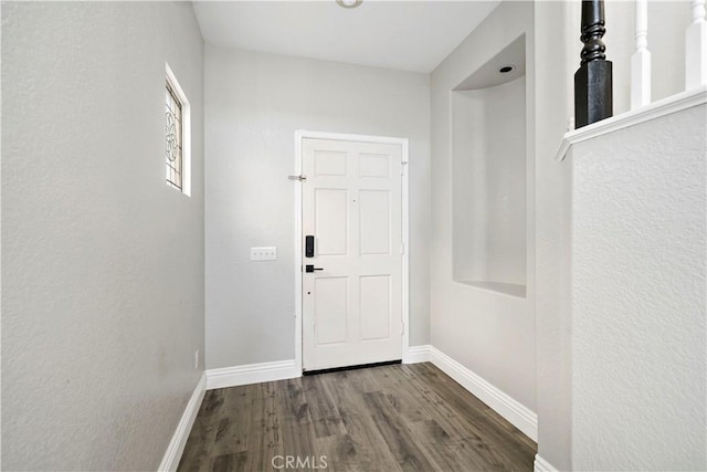 doorway to outside with dark wood-type flooring