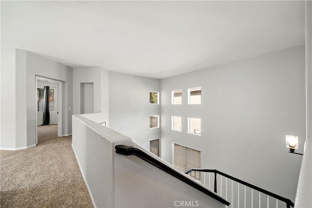 hallway featuring light colored carpet