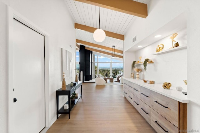 interior space with vaulted ceiling with beams, hardwood / wood-style floors, and wooden ceiling