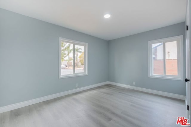 unfurnished room featuring light hardwood / wood-style floors