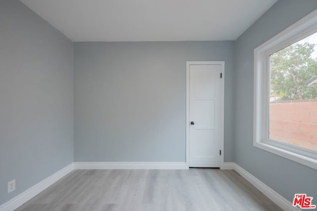 spare room with light hardwood / wood-style flooring and a healthy amount of sunlight