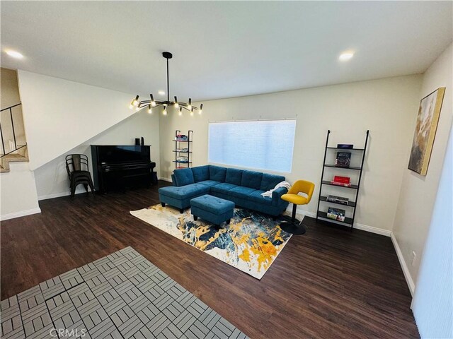 living room featuring dark hardwood / wood-style flooring and an inviting chandelier