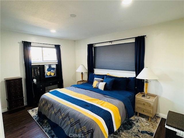 bedroom with dark wood-type flooring