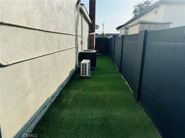 view of property exterior featuring a yard and central AC unit