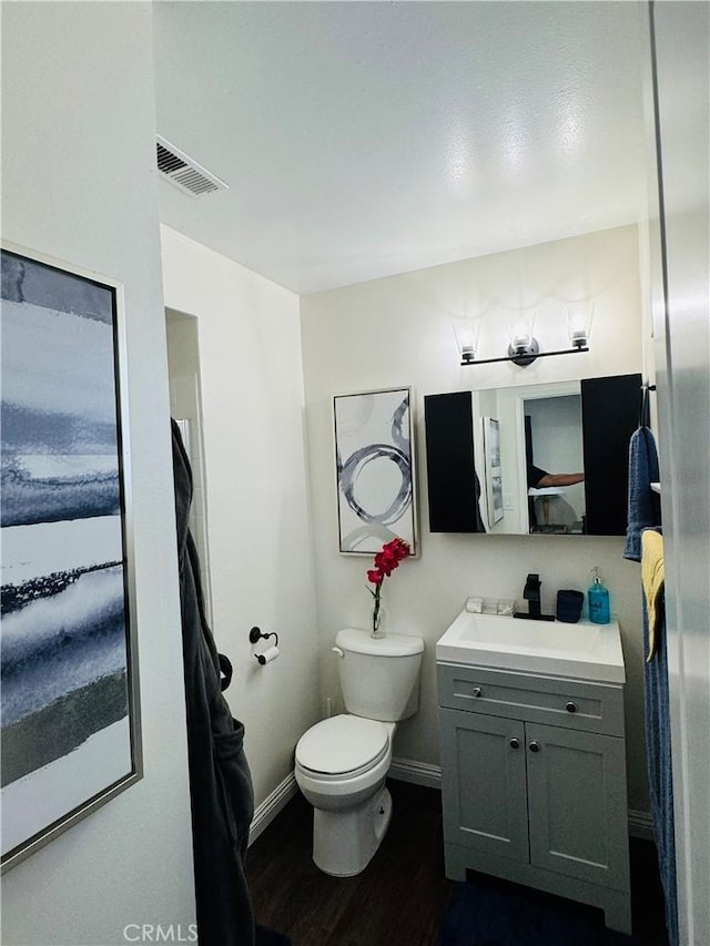 bathroom featuring hardwood / wood-style floors, vanity, and toilet