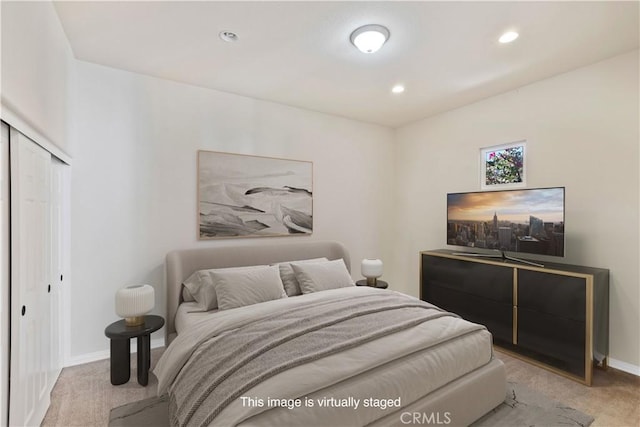 bedroom featuring a closet and light carpet