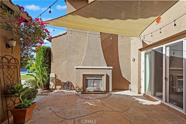 view of patio with a multi sided fireplace