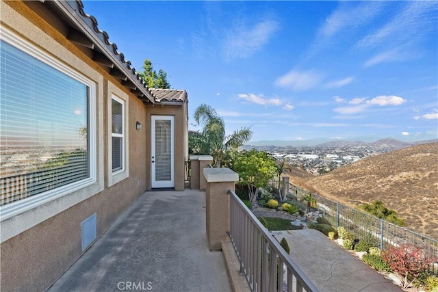 balcony with a patio and a mountain view