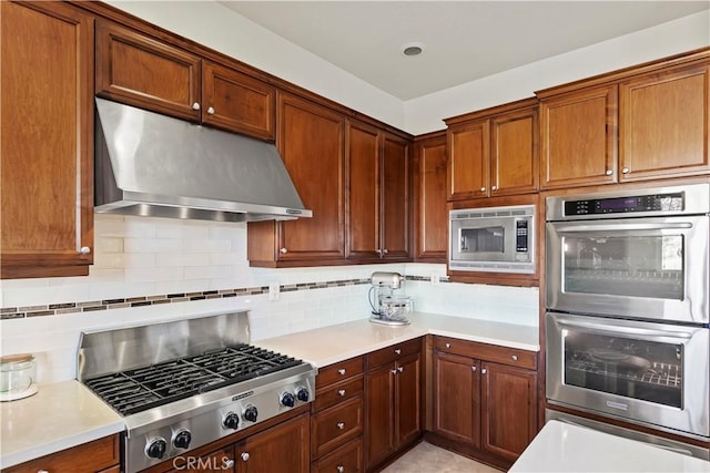 kitchen with stainless steel appliances and tasteful backsplash