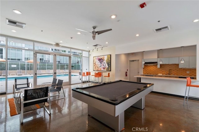 playroom with pool table, floor to ceiling windows, and ceiling fan