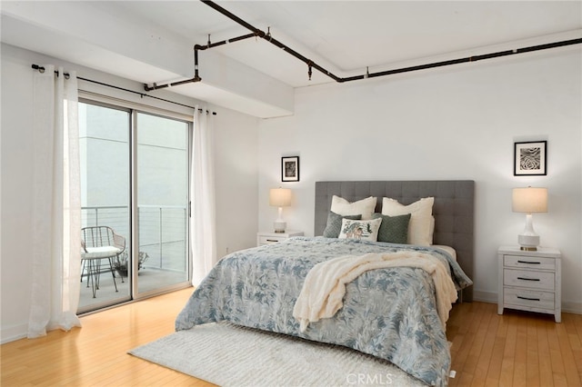 bedroom featuring light wood-type flooring and access to outside