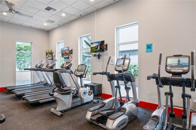 exercise room featuring a drop ceiling and ceiling fan