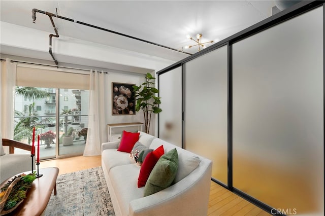 living room with a chandelier and light wood-type flooring