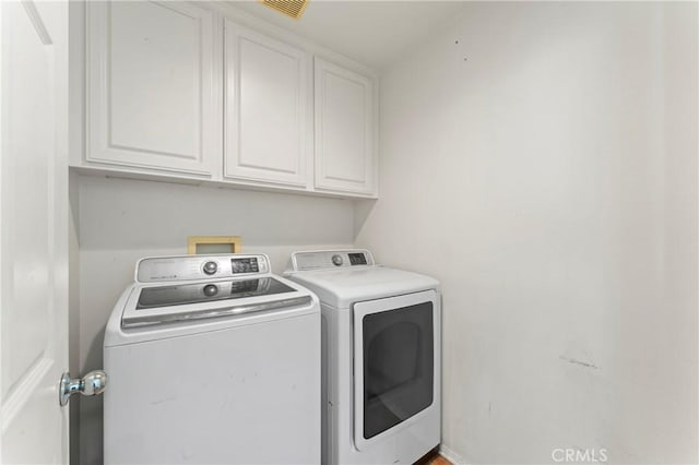 11465 Oakford Ln, Porter Ranch, CA 91326 - laundry area featuring separate washer and dryer and cabinet space