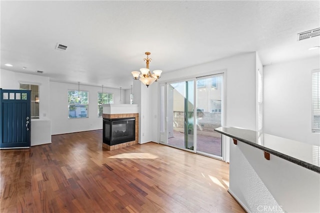 11465 Oakford Ln, Porter Ranch, CA 91326 - unfurnished living room featuring a chandelier, wood finished floors, and a tile fireplace