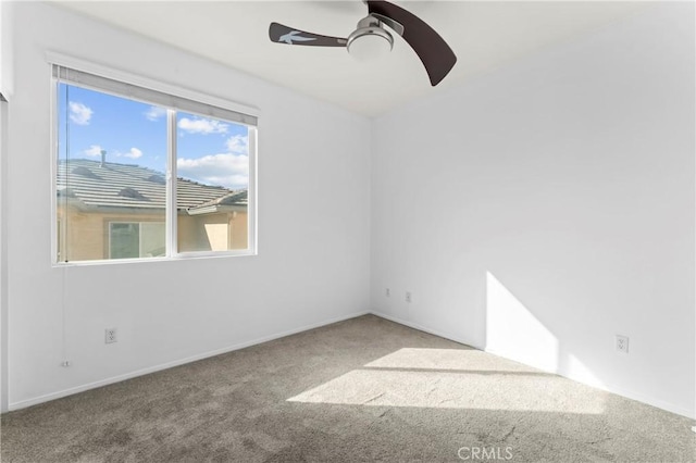 unfurnished room featuring ceiling fan and carpet floors