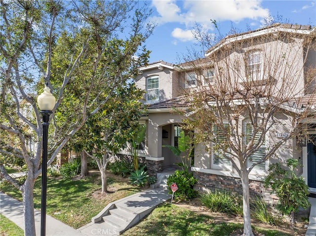 11465 Oakford Ln, Porter Ranch, CA 91326 - view of front of home featuring stucco siding and a front yard