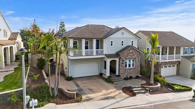 view of front of home featuring a balcony and a garage