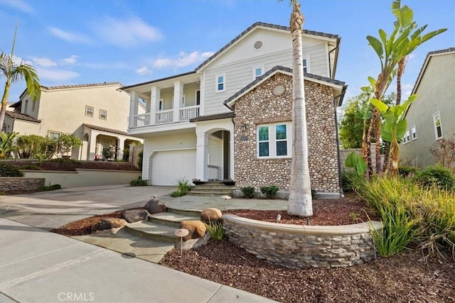 view of front of property featuring a garage and a balcony