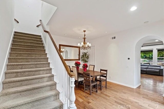 dining space featuring a notable chandelier and light wood-type flooring