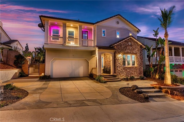 view of front of home with a garage and a balcony